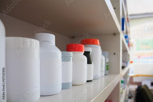 medicine bottles arranged on shelf at drugstore