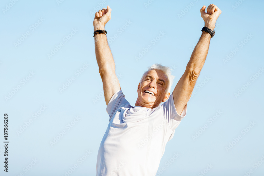 Handsome man in sport wear with outstretched arms Handsome man in sport wear with outstretched arms