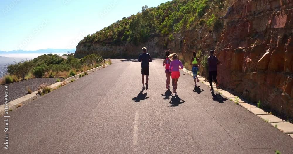 Team of athletes running outdoors on summer Team of athletes running outdoors on summer