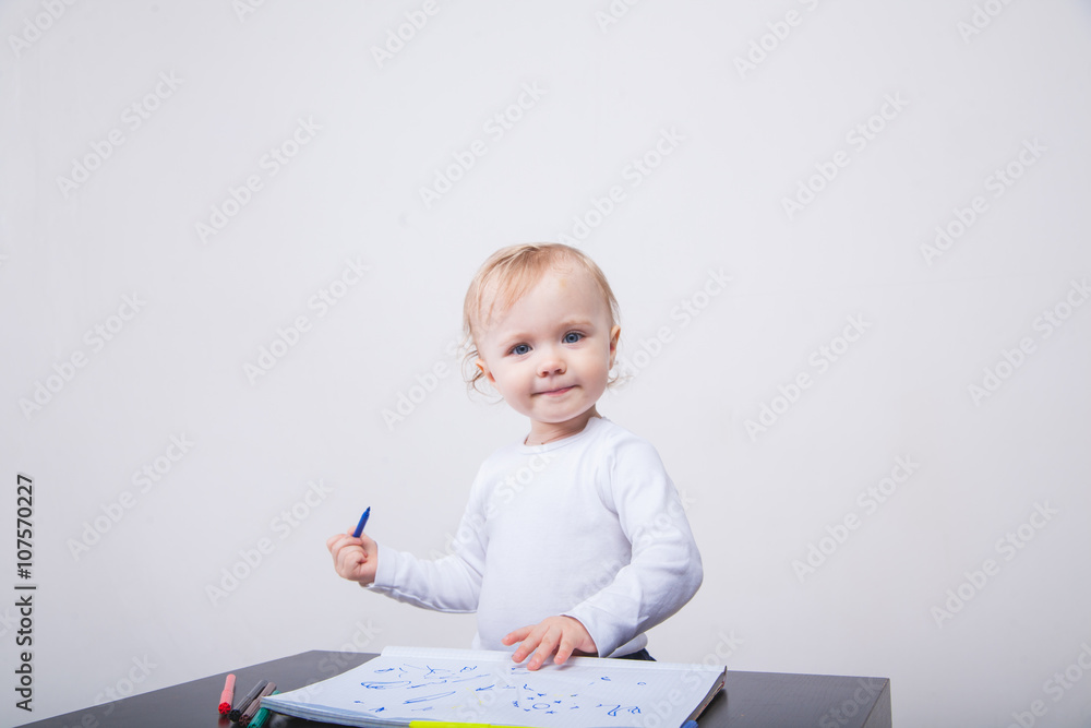 Baby girl drawing with colorful felt-tip pens white background Baby girl drawing with colorful felt-tip pens white background