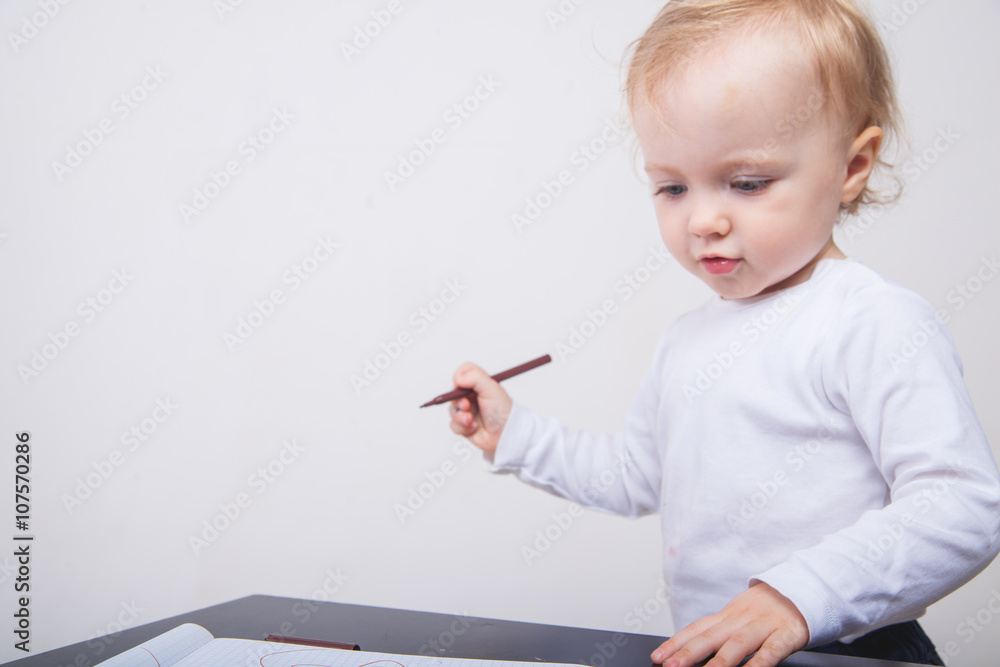 Baby girl drawing with colorful felt-tip pens white background Baby girl drawing with colorful felt-tip pens white background