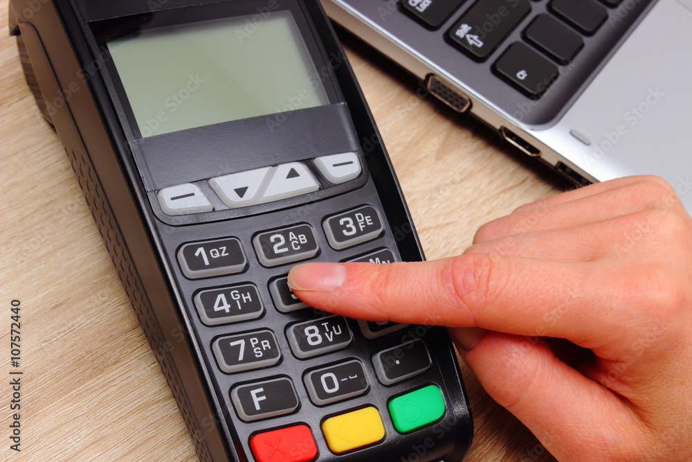 Hand of woman using payment terminal, enter personal identification number Hand of woman using payment terminal, enter personal identification number