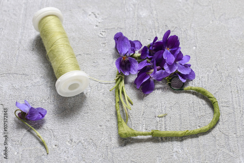Florist at work: steps of making viola odorata (violets) wreath