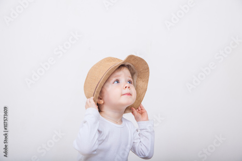 Little girl with hat on a white background.