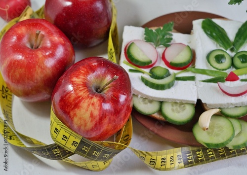 Diet - slimming .Weight loss concept with red apple, vegetables and dairy products
