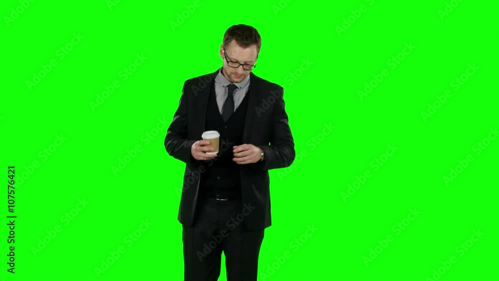 Business man walking and drinking cup of coffee. Green screen. Business man walking and drinking cup of coffee. Green screen.