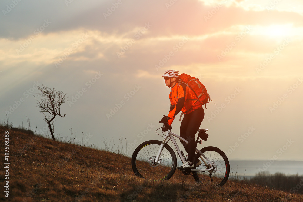 Fototapeta premium Man cyclist with backpack riding the bicycle