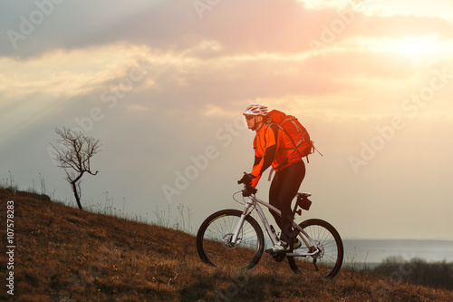 Man cyclist with backpack riding the bicycle