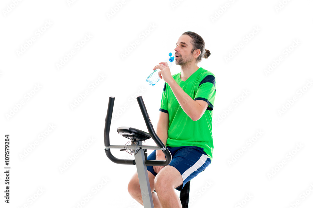 young man train with fitness machine and drinking water young man train with fitness machine and drinking water