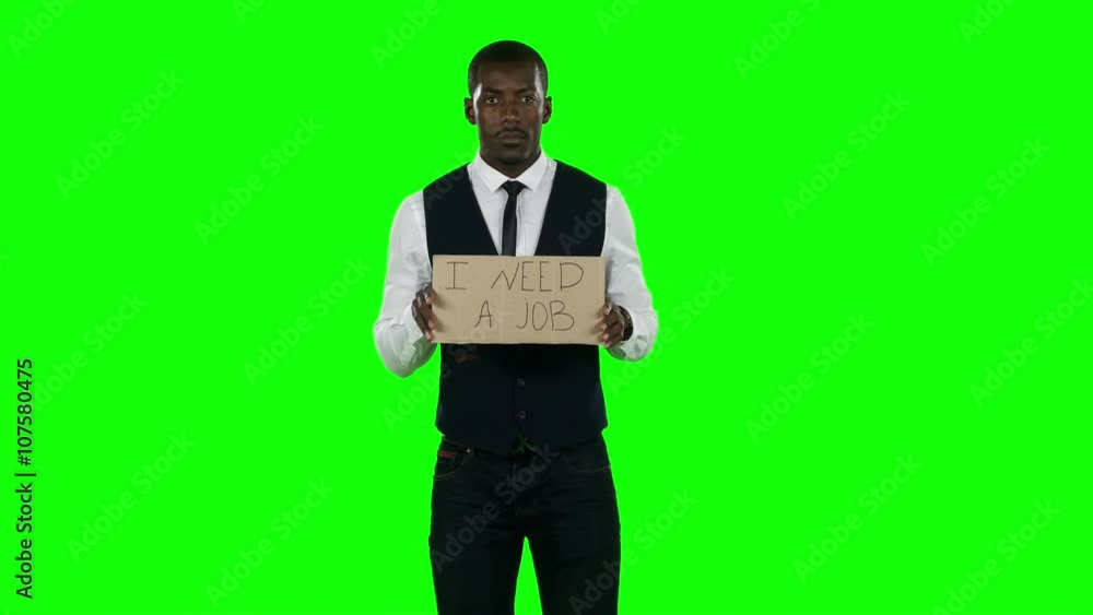 Businessman wearing a suit with a cardboard sign that asks about desire to find a job. Green screen Businessman wearing a suit with a cardboard sign that asks about desire to find a job. Green screen