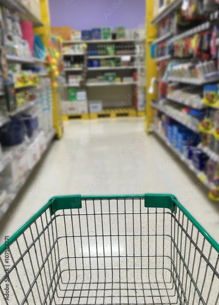 shopping cart in supermarket with blur background