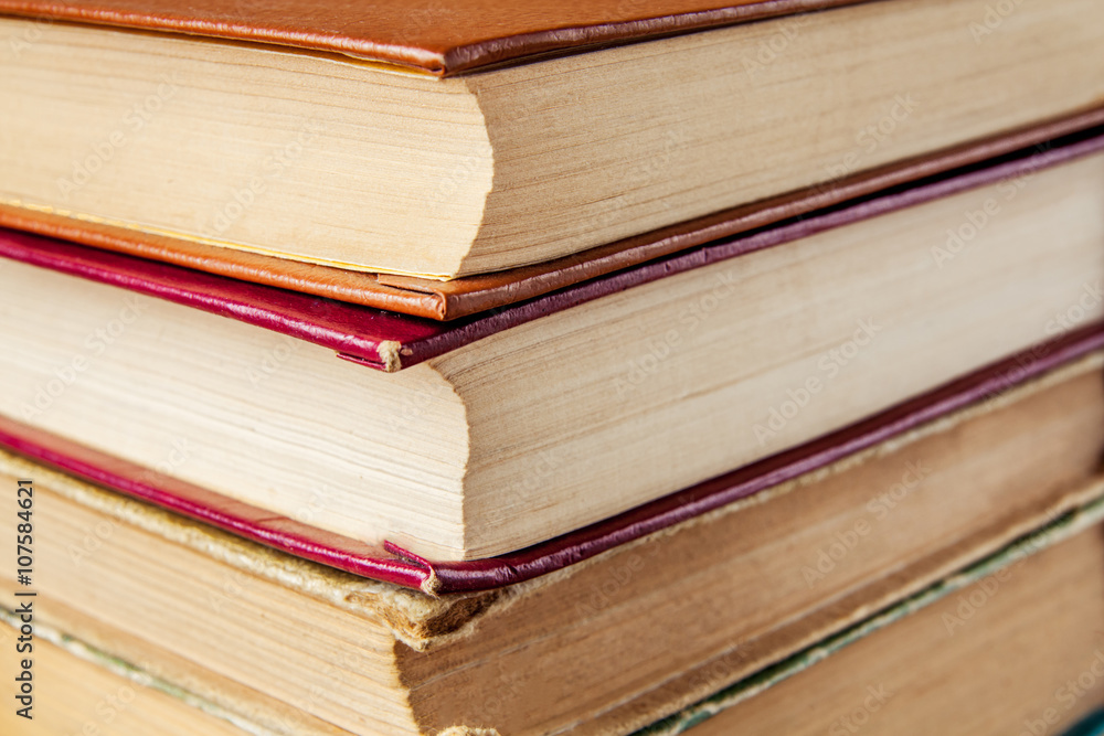 Old and used hardback books or text books seen from above. Old and used hardback books or text books seen from above.