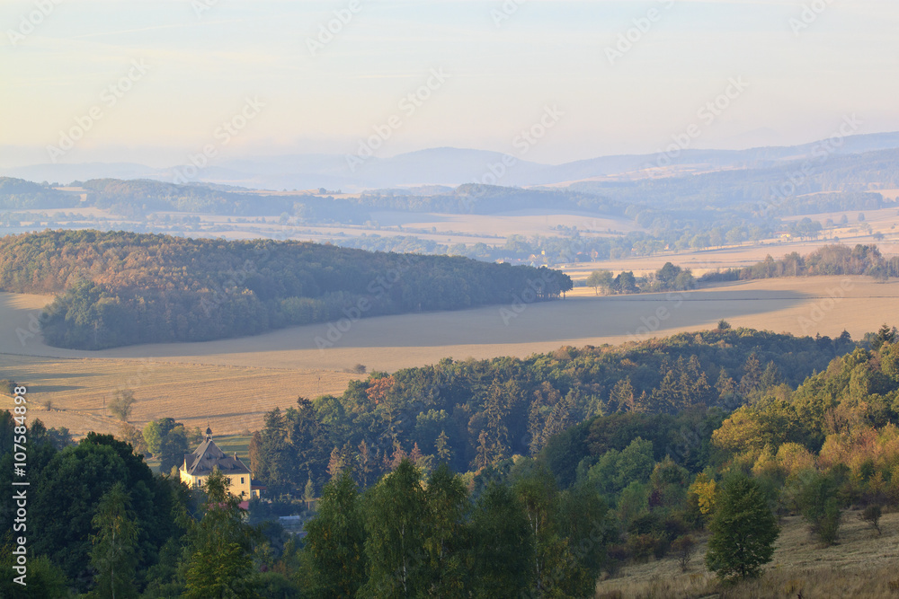 Hills and forest at autumn sunrise