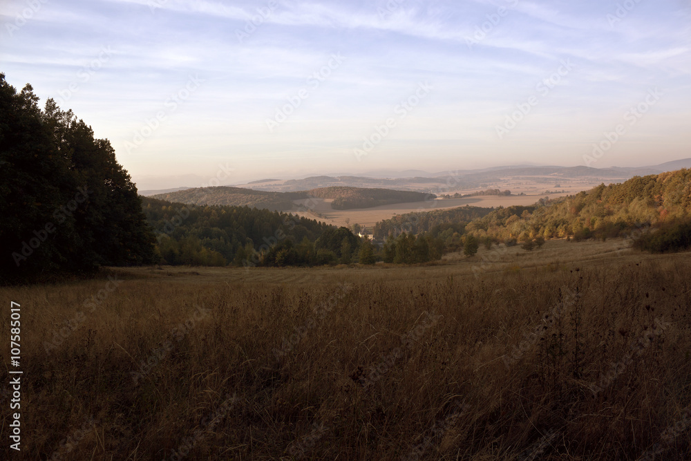 Hills and forest at autumn sunrise