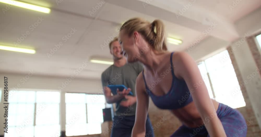 Girl exercising with weights headed by her personal trainer Girl exercising with weights headed by her personal trainer