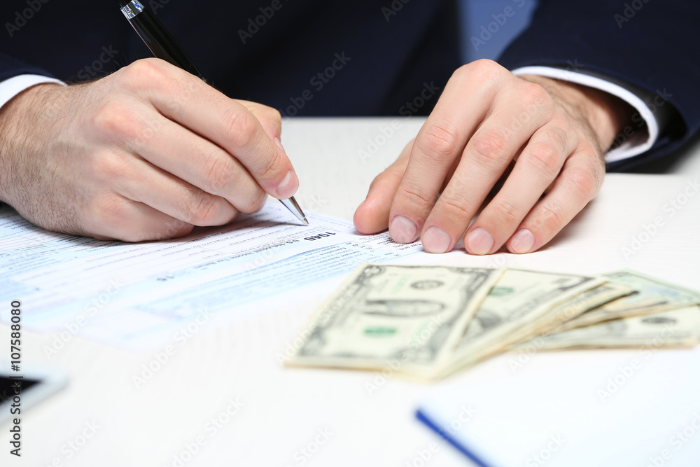 Man counting money and making calculations Man counting money and making calculations