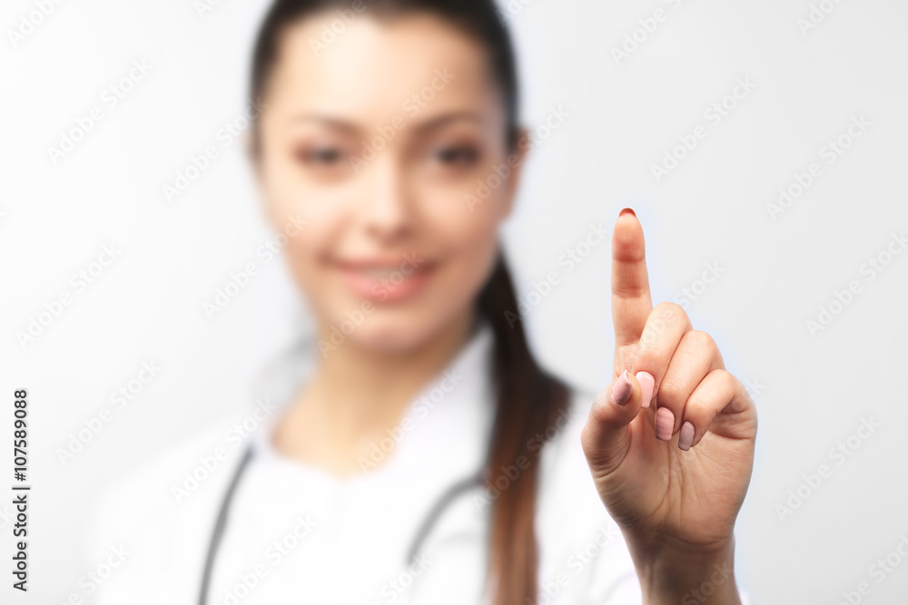 Young female doctor with pointing finger, close up Young female doctor with pointing finger, close up