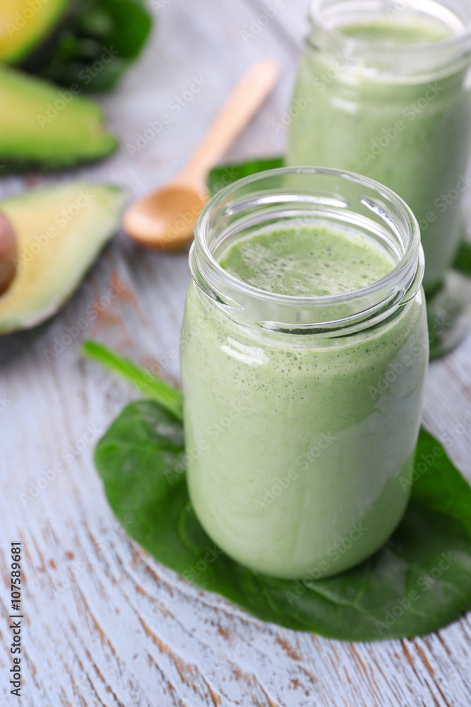 Avocado smoothie on wooden table closeup Avocado smoothie on wooden table closeup