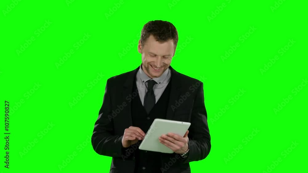Businessman watching something in laptop and smiling. Green screen Businessman watching something in laptop and smiling. Green screen