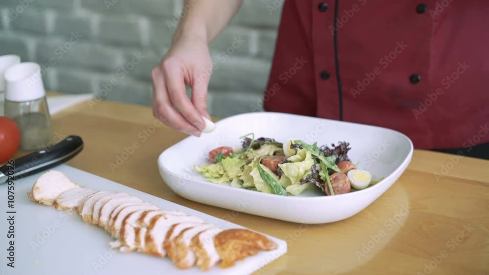 Woman hands decorating salad with eggs and meat 4k Woman hands decorating salad with eggs and meat 4k