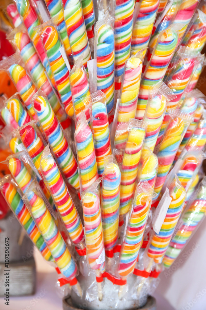 Close up of colorful handmade swirl lollipop on market