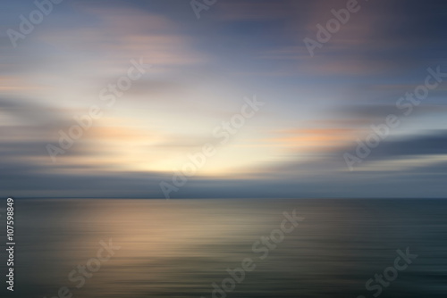 Beautiful vibrant sunrise landscape over calm sea wtih blur filt © veneratio