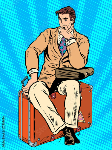 Man traveler sitting on a suitcase