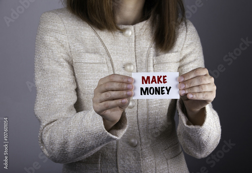 Make Money. Businesswoman holding a card with a message text wri photo