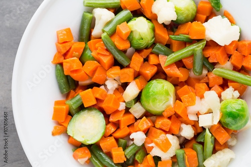 Fresh vegetables mix in a white bowl.