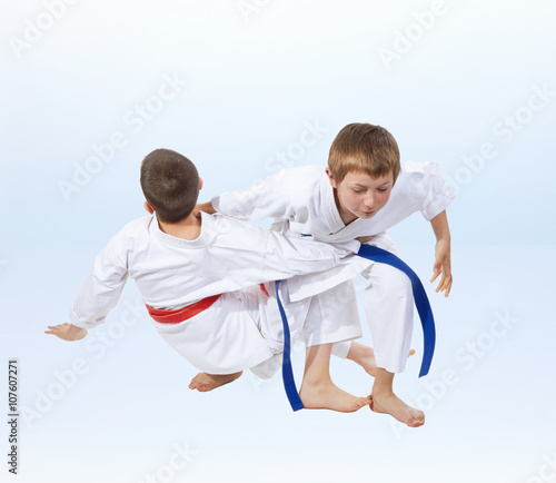 On a light background doing throws of judo athletes 