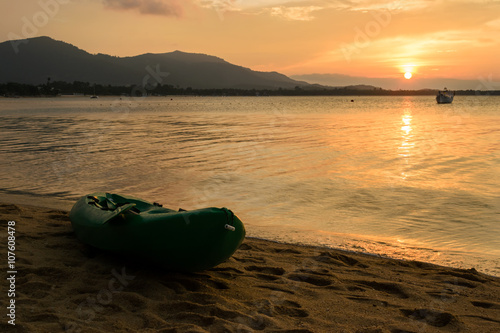 Canoe on the beach with Sunset on Koh Samui in Thailand