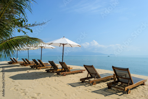 Beach chairs on the white sand beach with cloudy blue sky,Koh Samui in Thailand