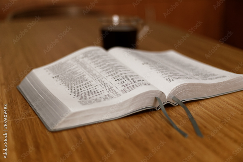 Fototapeta premium Bible on table. Holy Bible book on a background. The Holy bible on a wooden table. Christianity concept. Faith hope love concept. Christianity concept. Holy Bible background.. Faith hope love