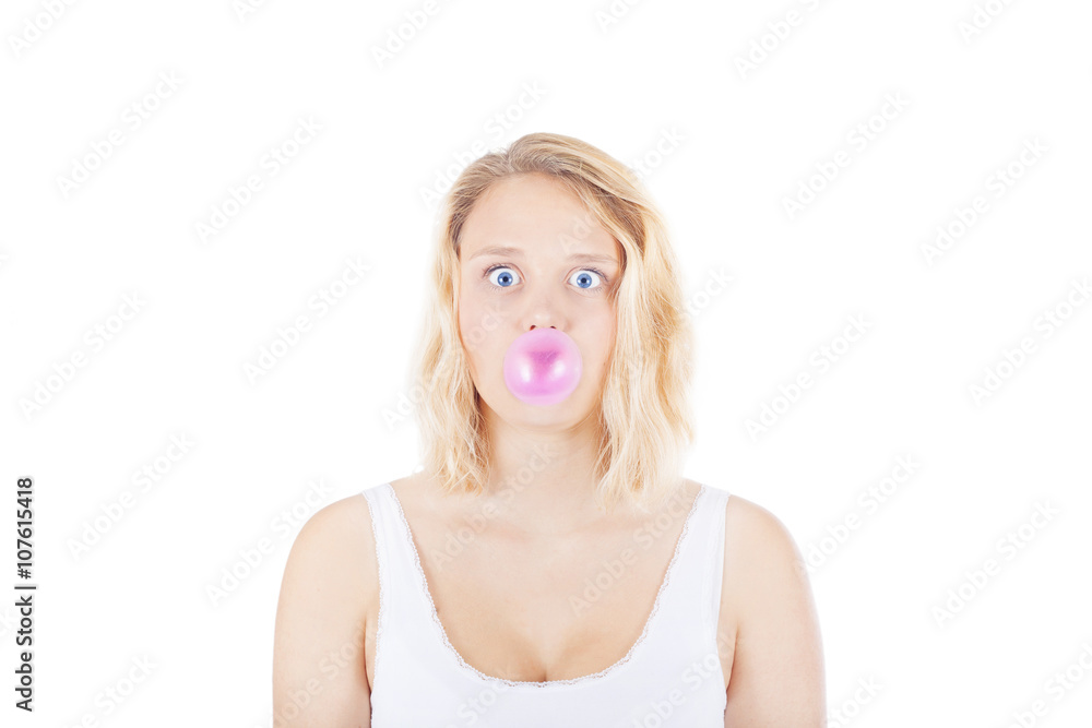 Blonde young woman or teenager blowing gum bubble on white background Blonde young woman or teenager blowing gum bubble on white background