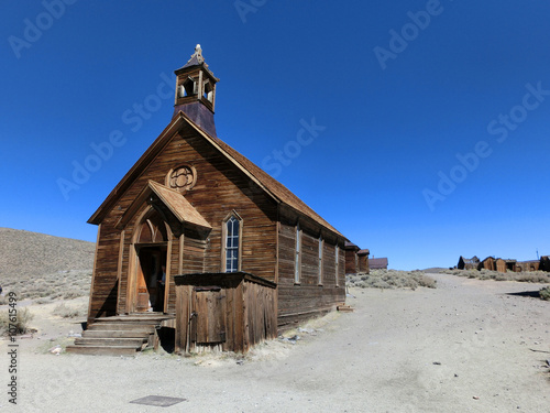 Old vintage weathered wooden church exterior in Bodie, California old west - landscape color photo