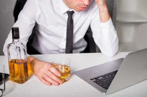 Man drinking at the office photo