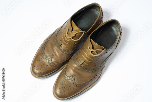 brown used budapester shoes on white background