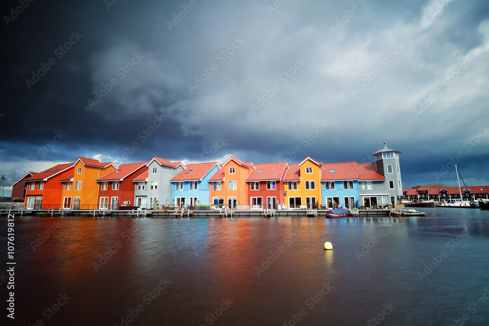 Obraz premium beautiful colorful buildings on water at storm