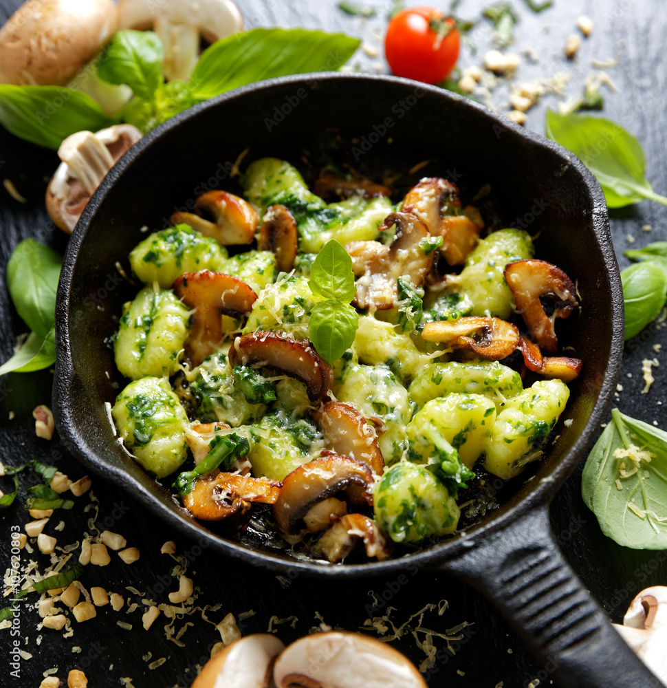 Potato Gnocchi with addition of herb pesto, cheese and mushrooms Potato Gnocchi with addition of herb pesto, cheese and mushrooms