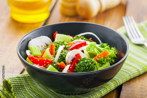 Healthy vegetable salad made of steamed broccoli, onion, mushroom, carrot and pepper. Vegetarian food.