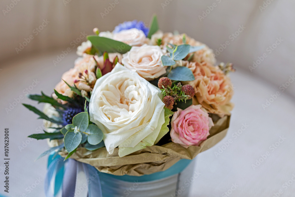 A bouquet of flowers in a bucket