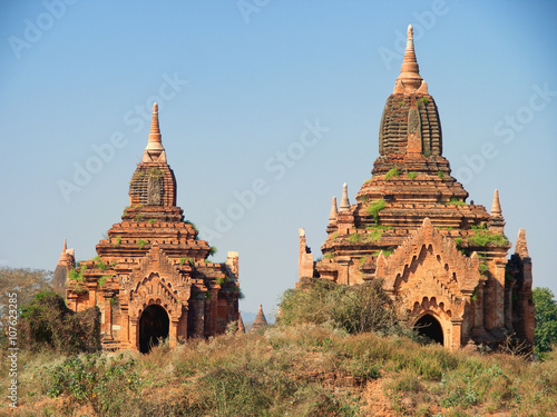 Two ancient pagodas in Bagan, Myanmar, blue sky in background