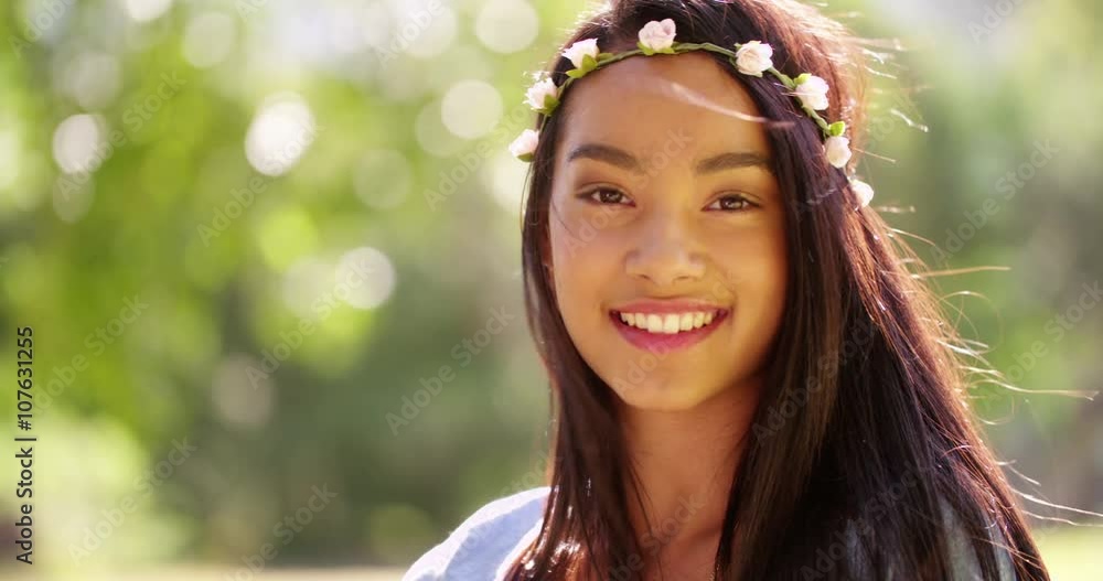 Mixed Race Woman with flowers in hair smiling in camera Mixed Race Woman with flowers in hair smiling in camera