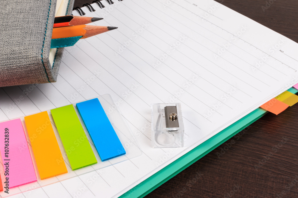 Notebook, paper note with pencil on wooden table. Notebook, paper note with pencil on wooden table.