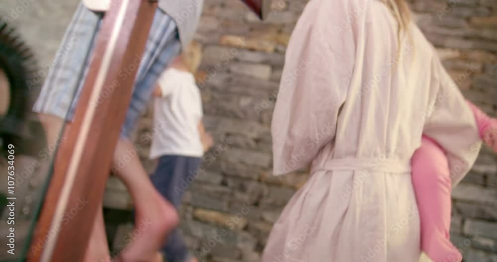 Parents walking upstairs with their small kids