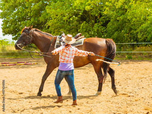 Western cowgirl woman with horse. Sport activity