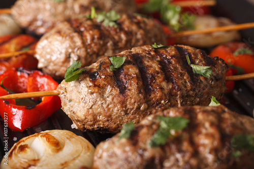 Turkish kebab with vegetables macro on a grill pan. horizontal
