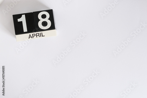 April 18th. Image of april 18 wooden color calendar on white background.  Spring day, empty space for text. International Day For Monuments and Amateur Radio