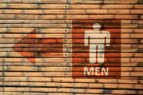 Male Toilet Signs on brown bamboo wood wall