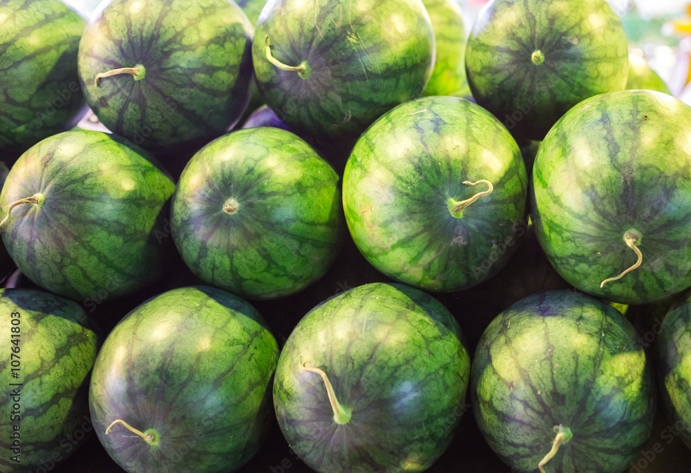 Many big sweet green watermelons and one cut watermelon Many big sweet green watermelons and one cut watermelon